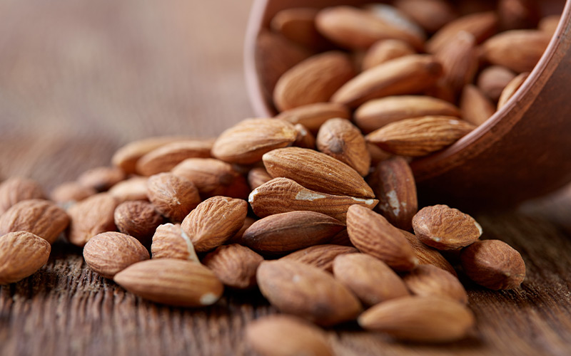 Close up shot of almonds being poured on the table.