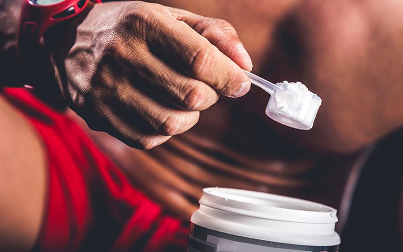 Athlete Scooping Supplements