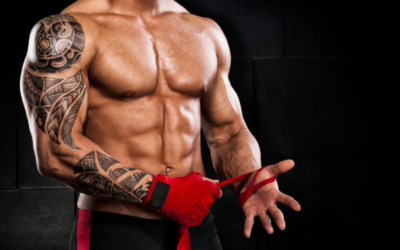 bodybuilder puts on lifting straps