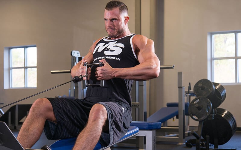 Guy performing cable rows for bulking season