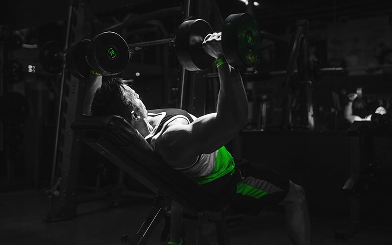 Man performing Incline Dumbbell Press