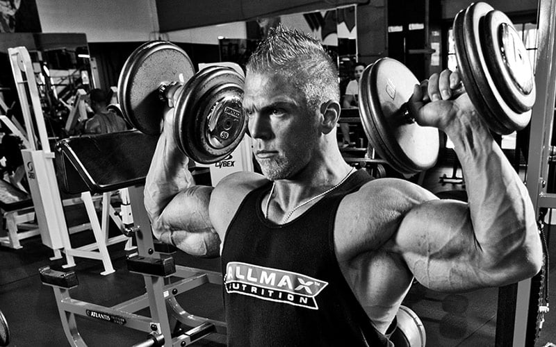 Man Performing Dumbbell Shoulder Press