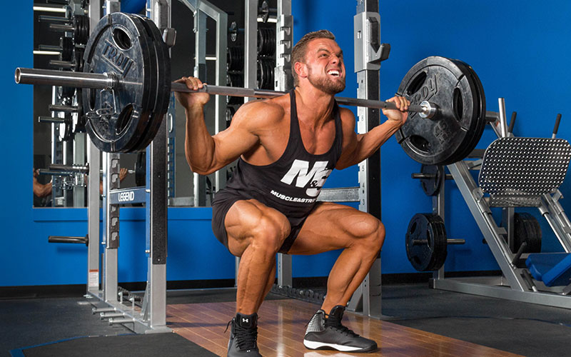 Male Athlete Performing EMOM Squats