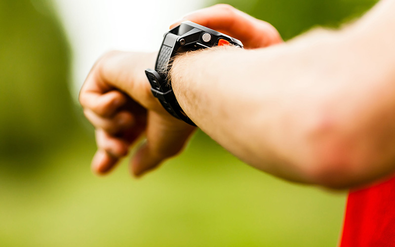 Man looking at a GPS Tracker