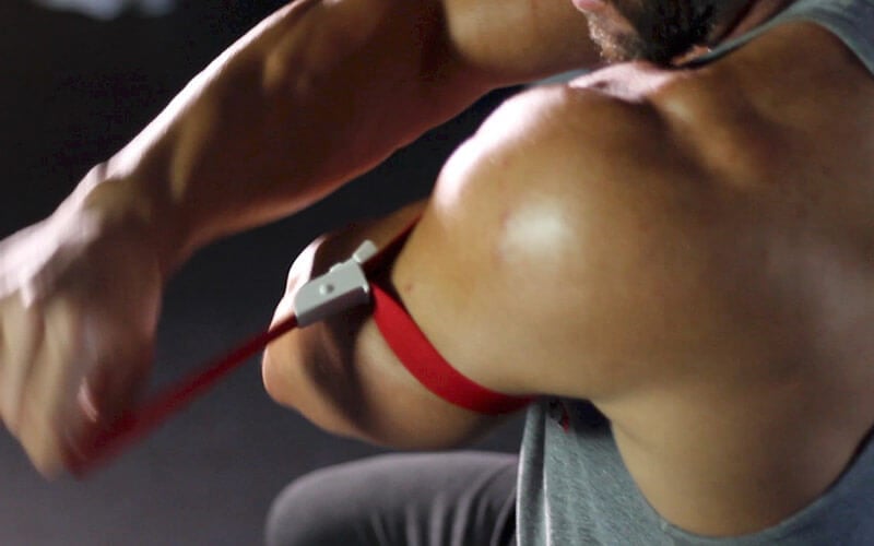 Athlete putting on a blood flow restriction band