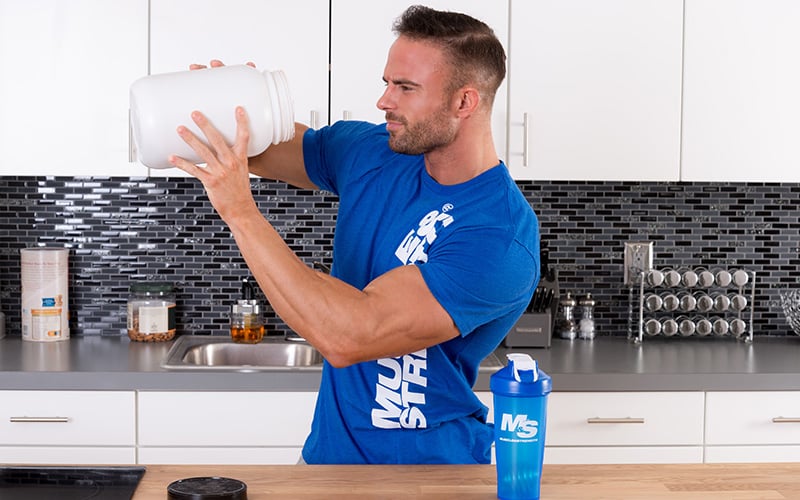 M&S Athlete Looking into a tub of protein