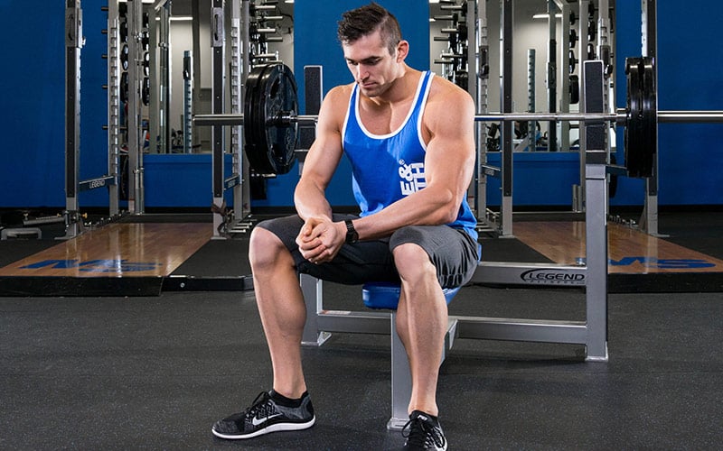 Man Sitting on Bench Press