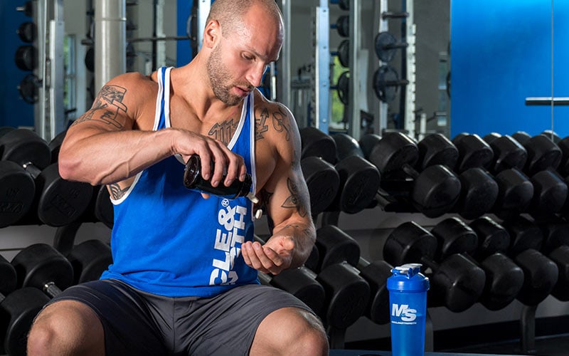 Natural Lifter Pouring Supplements into Hand