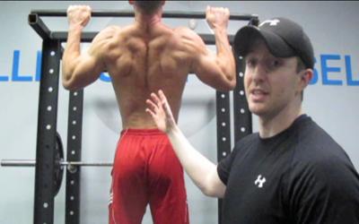 Man doing pull up in the gym