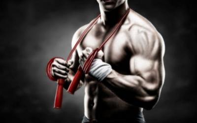 Shirtless man holding jump rope