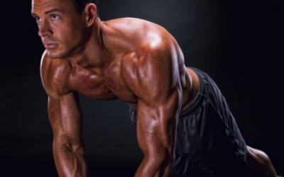 Shirtless man doing a close grip push up