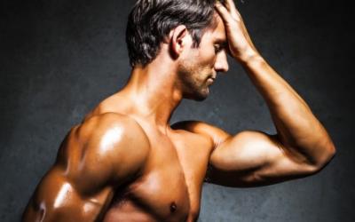 Fit man standing with palm on his face