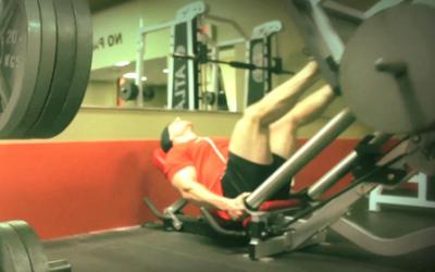 Bodybuilder doing a 45 degree leg press