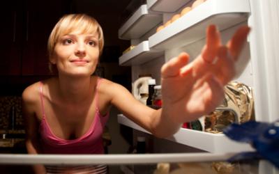 Fit woman looking in the fridge