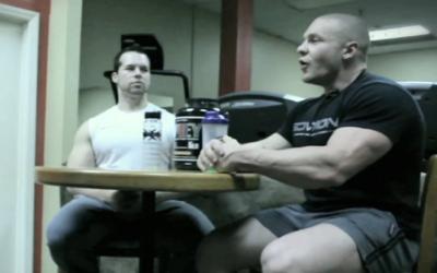 Two large man talking at a table