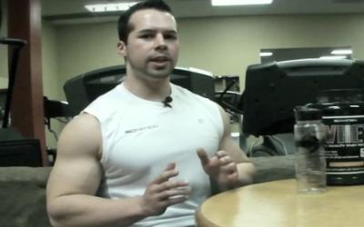 Ripped man in white shirt talking