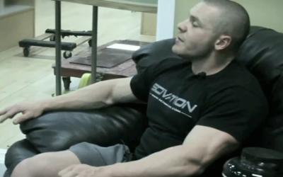 Bodybuilder man sitting in armchair
