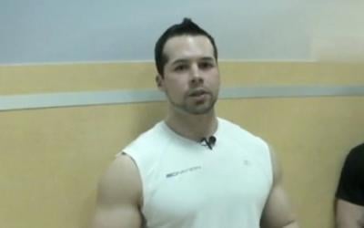 Fit man standing in sleeveless shirt