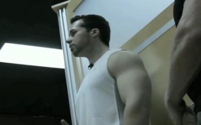 Bodybuilder standing in the gym in sleeveless shirt
