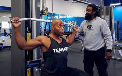Charles Glass coaching man doing lat pull down