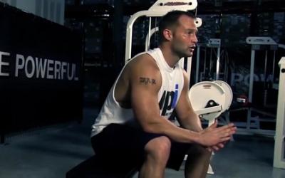 Man sitting in gym in tank top