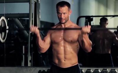 Man doing barbell bicep curl in the gym