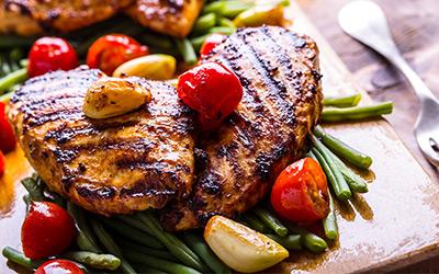 Close up of fresh grilled chicken and mixed vegetables.