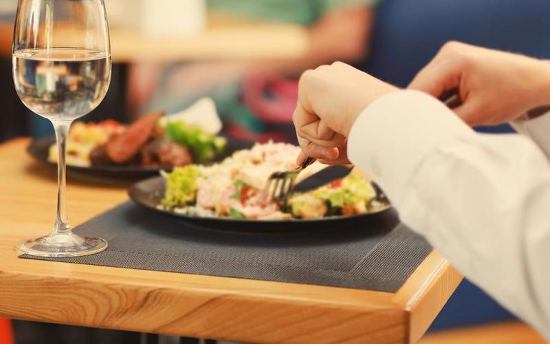 Close up of someone eating at a restaurant
