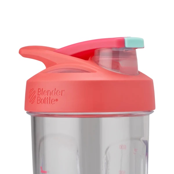 Coral pink Blender Bottle with turquoise flip-cap lid and measurement markings, close-up of top portion.