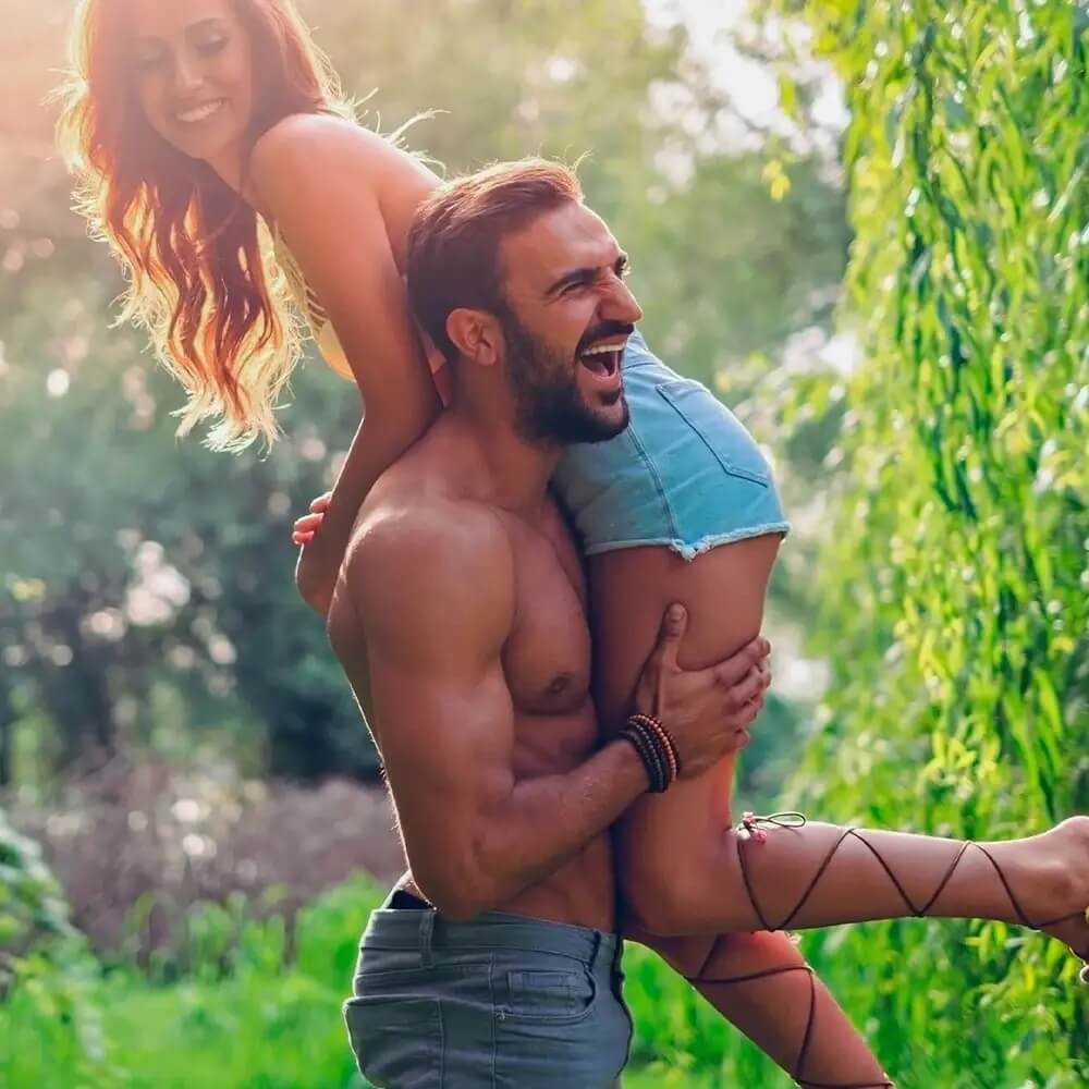 Lifestyle image of a confident couple embracing outdoors