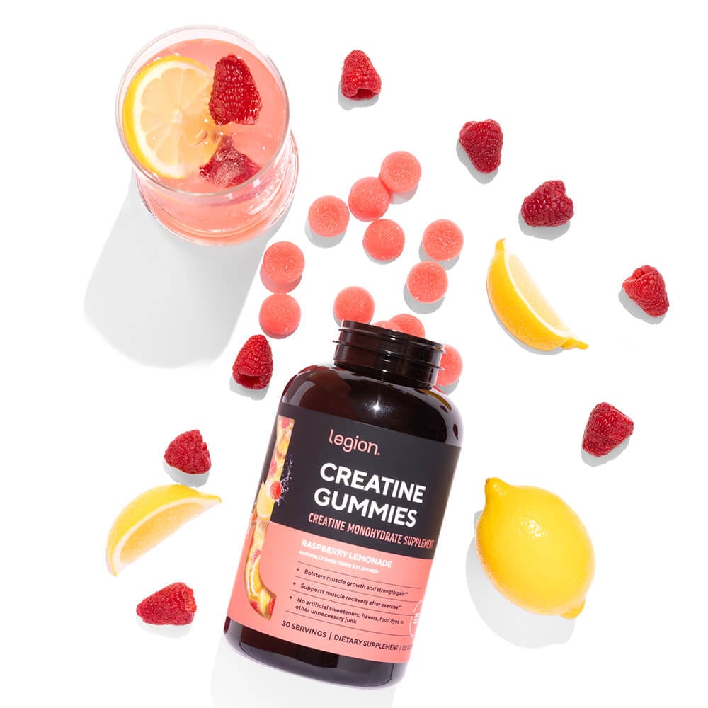 Legion Creatine Gummies Raspberry Lemonade surrounded by fresh raspberries and lemon slices