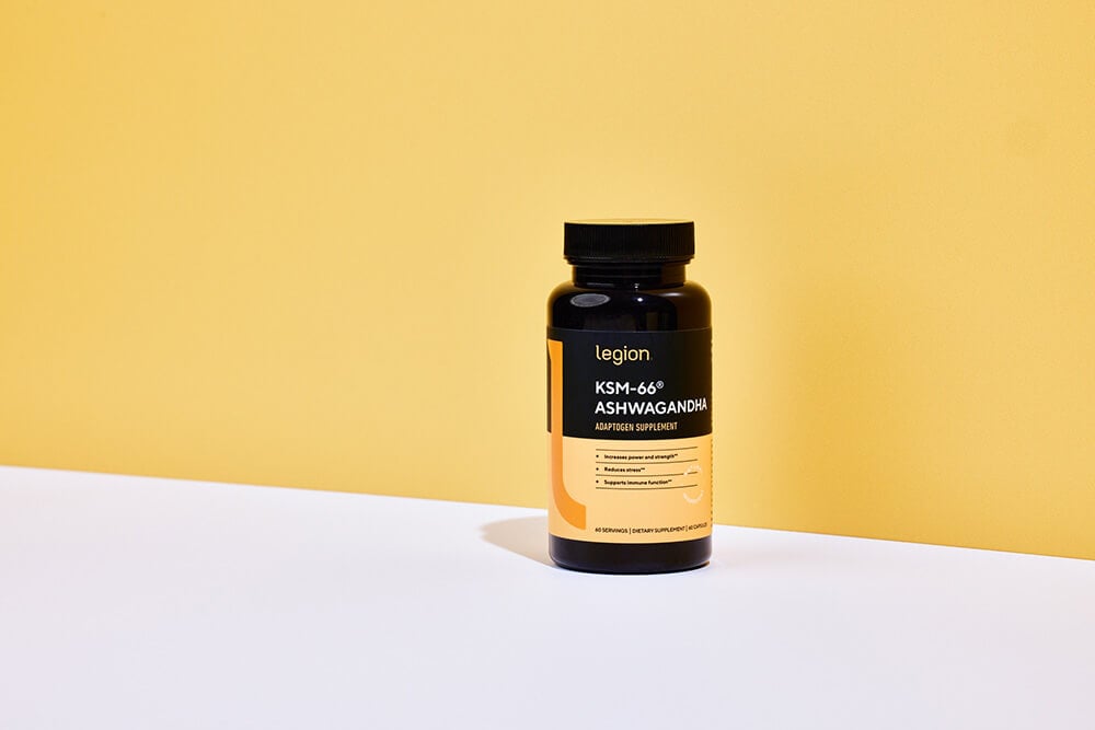 Legion KSM-66 Ashwagandha Adaptogen Supplement bottle on a yellow and white background