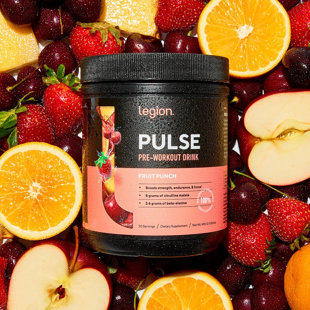 Legion Pulse Fruit Punch pre-workout drink surrounded by fresh fruits