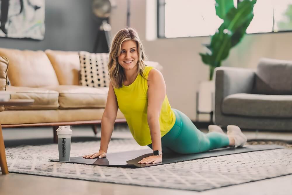 female athlete doing yoga in living room