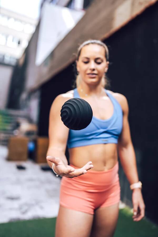 Female athlete tossing ripple ball into the air